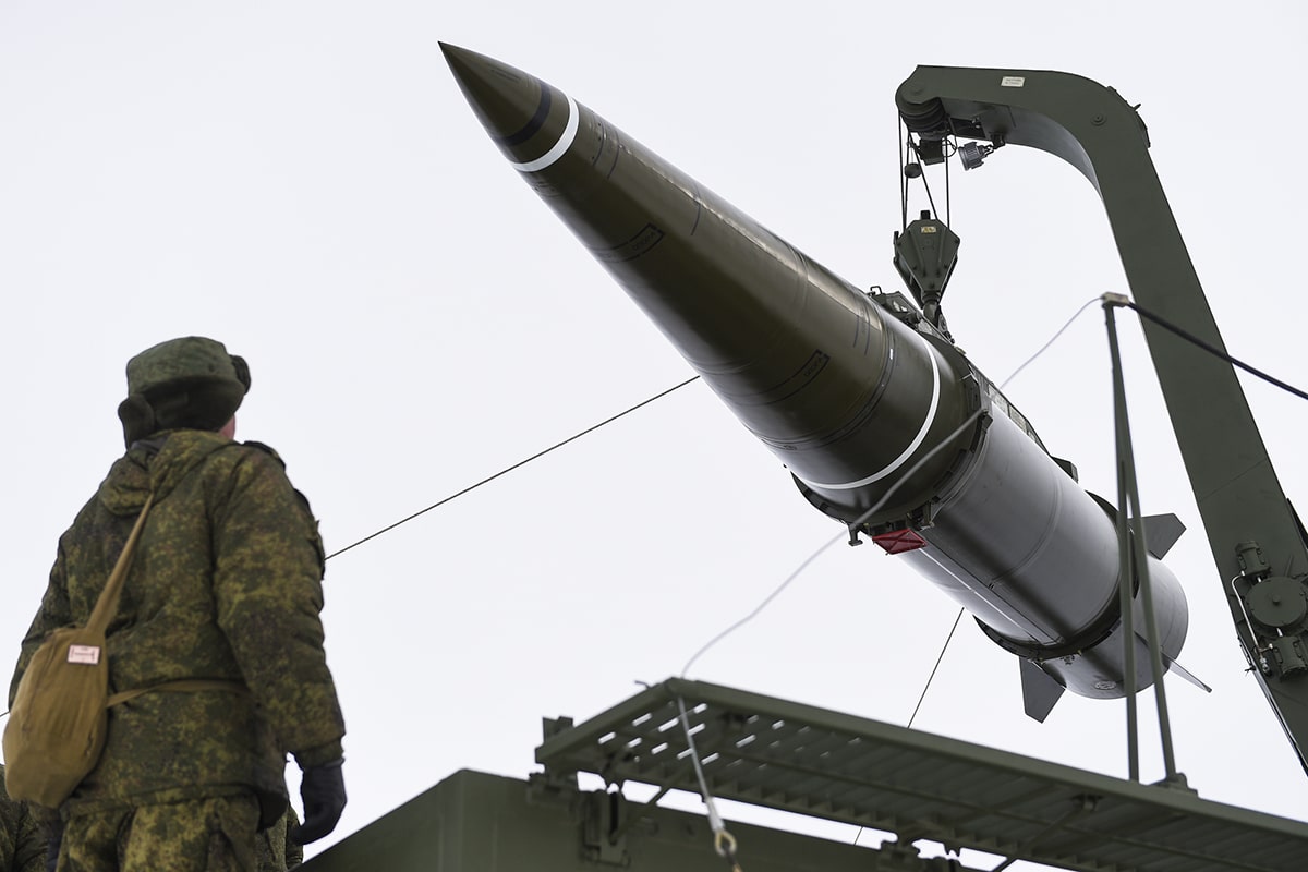 Iskander missile on the loading crane with a soldier