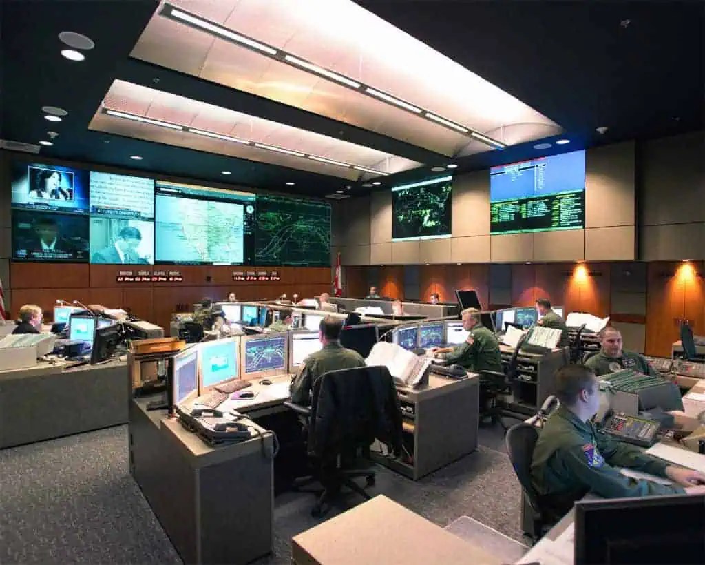 Modern operations center with a video wall and rows of consoles