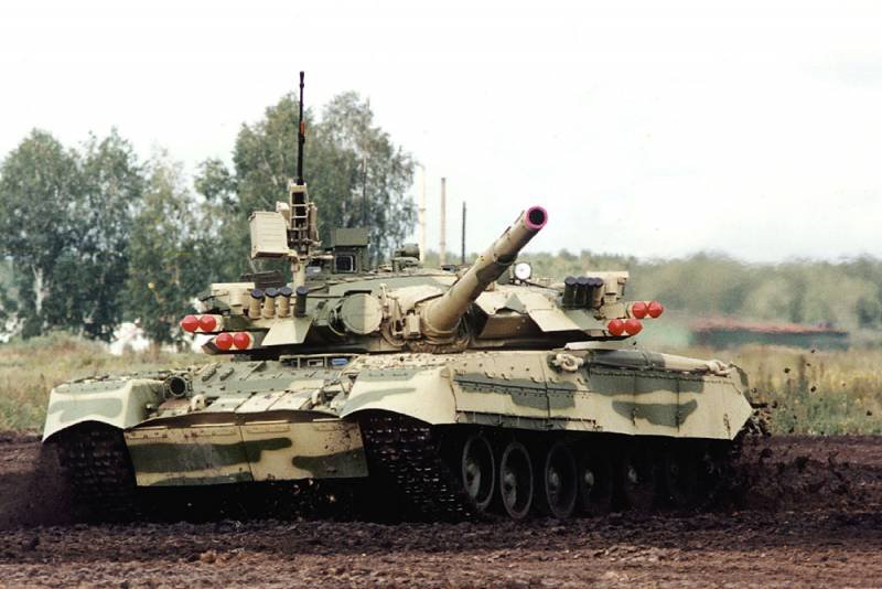 T-80 with Drozd-2 launchers driving in a field