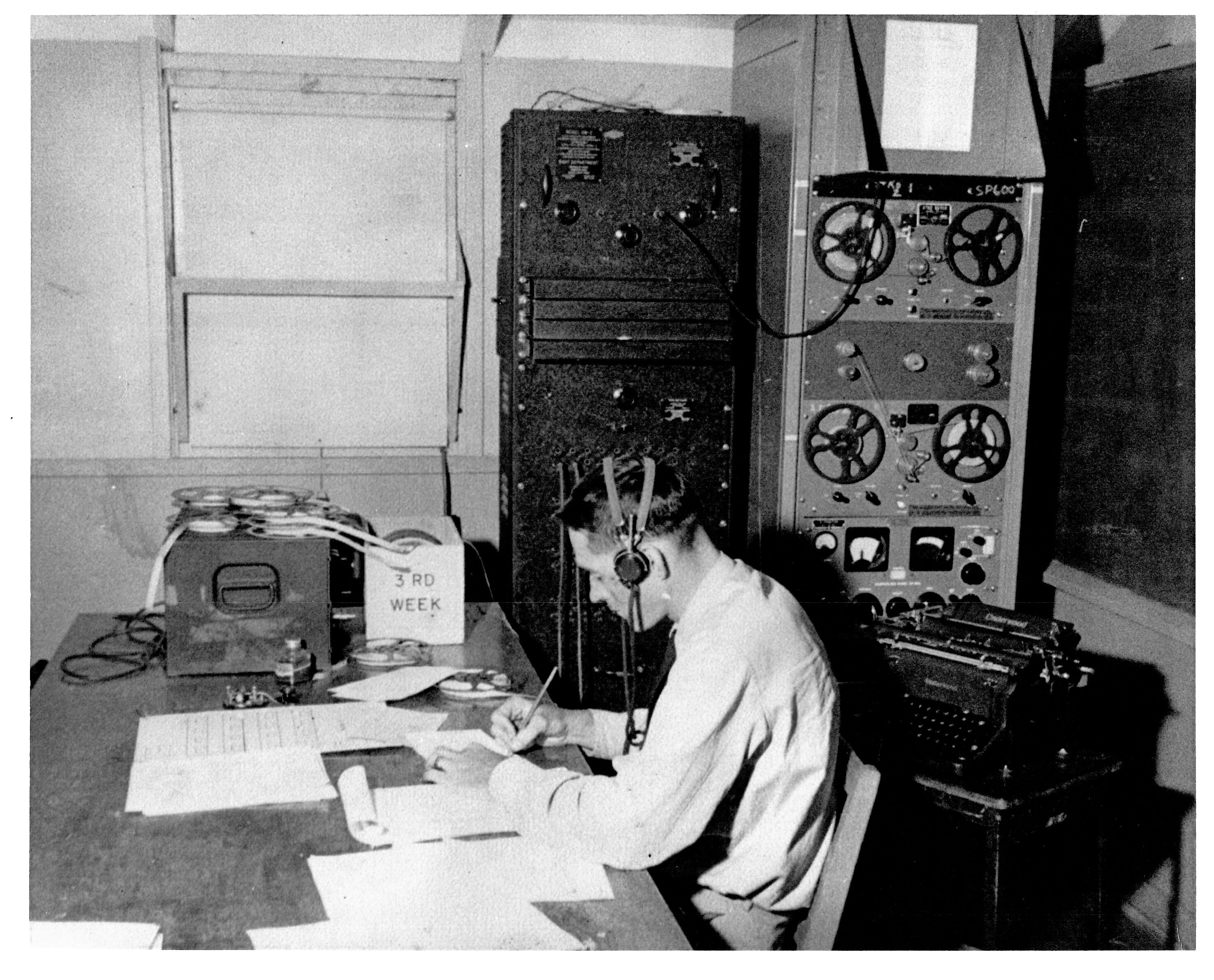 Intercept operator with headphones, tape gear and typewriter
