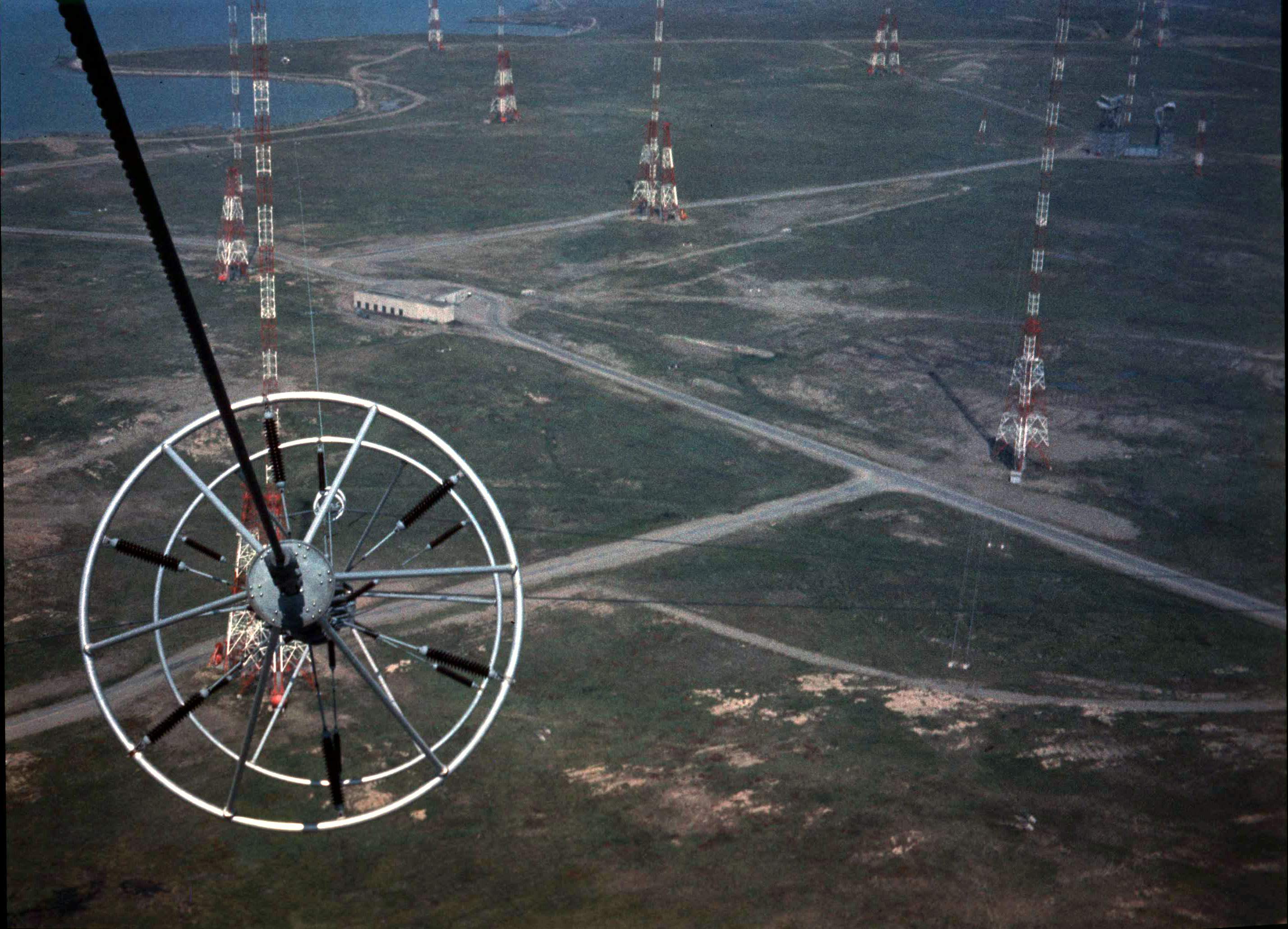 Aerial view of towers and roads with a ring fitting on a cable in the foreground