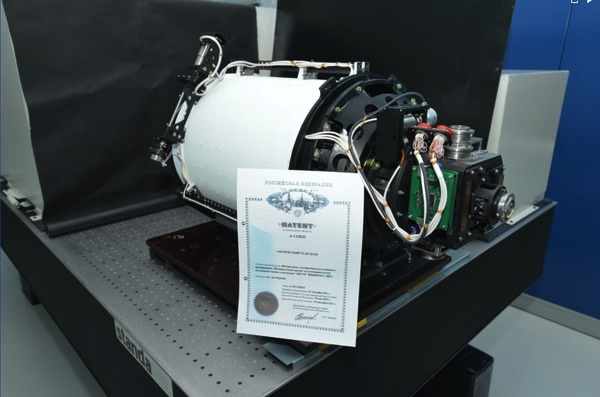 Optical telescope unit on a laboratory bench with a Russian patent certificate in front